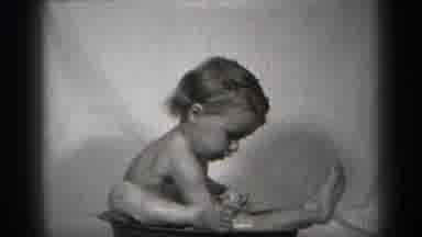 Cleveland Ohio (1938): A Little Child Plays With Doll While Taking A Bath