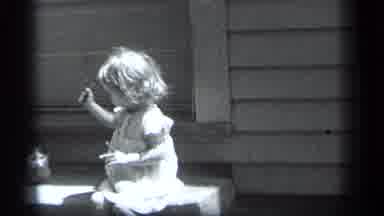 Cleveland Ohio (1939): Young Girl In Frilly Dress With Lollipop Sitting On Step