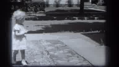 Cleveland Ohio (1939): Little Blond Girl With Lollipop Waving And Walking Down