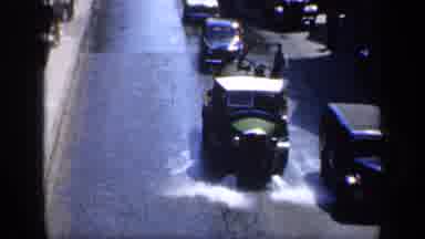 England (1949): European Bus Driving Down A Flooded Street On A Sunny Day