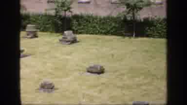 England (1949): Seven Grey Stone Objects Standing In Green Lawn On A Bright Sunny