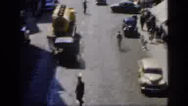 England (1949): Old Classical Car Going In A Street People Are Walking In The