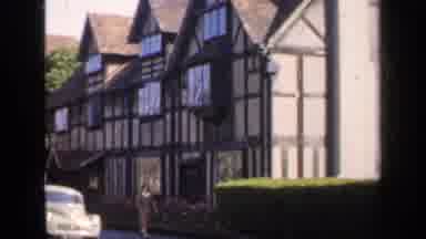 England (1949): People Walk By The House The Has A Odor Style Decor On The Front