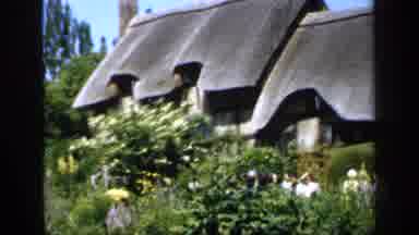 England (1949): Old House In The Nature Surrounded By Plants And A Woman Standing