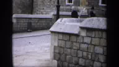 England (1949): A London Guard Walking Around A Stone Wall Corner