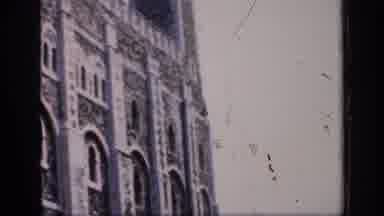 England (1949): Guards Wearing Red And Black Uniforms Stand Next To Grey Cathedral