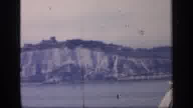 England (1949): Boat Drifts Lazily Through The Water The Sits Under The Mountains