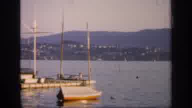 England (1949): Sailboats Moored In Harbor With Village And Mountains In