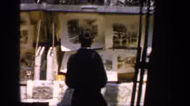 France (1949): People Examining Photographs Displayed Outdoors