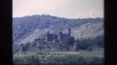 IRELAND-1949: Distant Castle Sits On Side Of Large Green Cliff