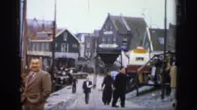 IRELAND-1949: People Walking Down Small Business Side Street Near The Docks
