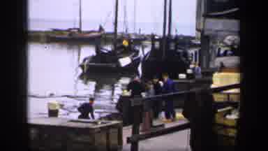 IRELAND-1949: Young Boy On Cobblestones And Fishermen At Harbor