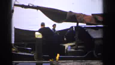 Ireland (1949): Three People On A Boat While One Person Stands On The Dock