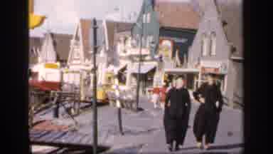 Ireland (1949): People Walking Along Piers And Surf While The Wind Blows In An