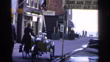 IRELAND-1949: Man And Woman Walking Outside Next To Bicycle In City