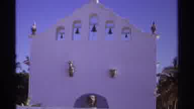 Cabo San Lucas Mexico (1974): Bells On A White Brick Wall With A Blue Sky Behind