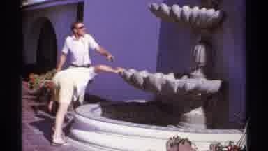 Cabo San Lucas Mexico (1974): Male Tourists Looking Studying Water Fountain