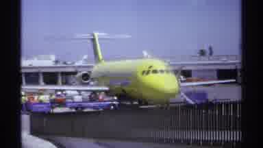 LA Paz Mexico-1974: Yellow Plane Cargo Being Loaded At Airport