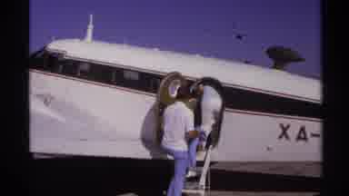 La Paz Mexico (1974): Two Men Slowly Climb Into Small Commuter Plane Parked On