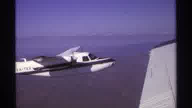 La Paz Mexico (1974): View Of White Airplane In Flight On A Sunny Day