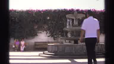 Guaymas Mexico (1975): Man Wearing White Shirt Waves To Sitting Women Wearing Pink