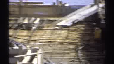 Guaymas Mexico (1975): Man Wearing Brown Pants Carries Grey Bucket On Back On A