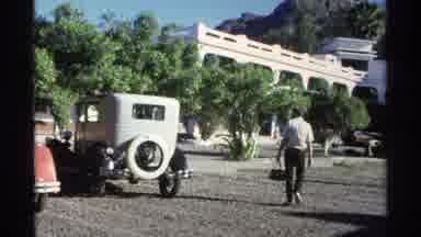 Guaymas Mexico (1975): Man Walks Towards The White Car While Carrying A Black Bag