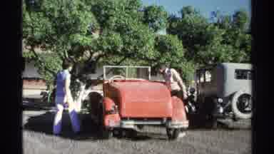 Guaymas Mexico (1975): Two Men Examine Their Red Old Car