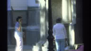 Guaymas Mexico (1975): Woman Wearing White Pants And Sunglasses Waves At Camera