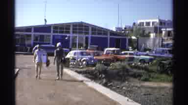 Guaymas Mexico (1975): Old Footage Of Two People Walking Away From A Blue Building