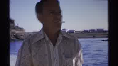 Guaymas Mexico (1975): Man In Speedboat Clinches A Cigarette Between His Lips As