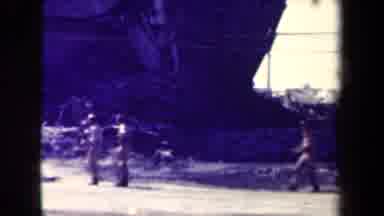 Manilla Philippines--1944: Military Walks And Drives Through Ruins Of A Building