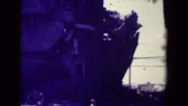 Manilla Philippines--1944: View Of Damaged Wooden Structure Amidst Rubble On A Sunny Day