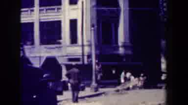 MANILLA PHILIPPINES--194: Man Wearing Tan Shirt Walks Down Street On A Sunny Day