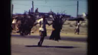 MANILLA PHILIPPINES--194: Man Wearing Yellow Shirt Carries Two Bundles Of Wood