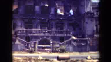 MANILLA PHILIPPINES--194: Pair Of Black Trucks Drive By Grey Building Facade On