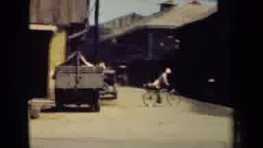 MANILLA PHILIPPINES--194: People Riding Bikes And Carriages In Rural Background