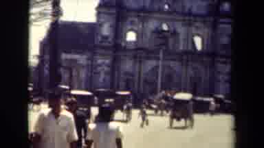 MANILLA PHILIPPINES--194: View Of Pedestrian Traffic Passing By Facade Ruins On