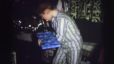 MOBILE ALABAMA-ile-: Young Boy In Pinstripe Pajamas Opening A Present Wrapped In
