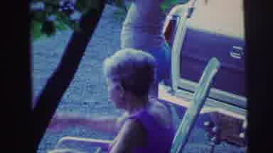 MOBILE ALABAMA-ile-: Woman Sitting Outside Near A Car And Two Other Adults