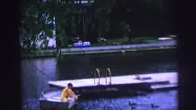 MOBILE ALABAMA-ile-: Man Feeding Ducks While On A Boat In A Lake