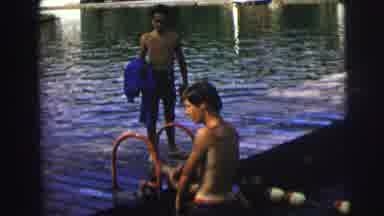 MOBILE ALABAMA-ile-: Man Wearing Brown Shorts Climbs Out Water On A Sunny Day