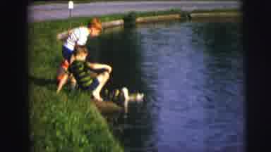 MOBILE ALABAMA-ile-: Young Boys On A Riverbank Feeding Group Of Swimming Ducks