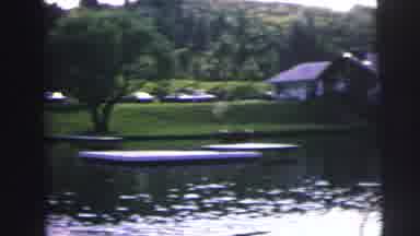 MOBILE ALABAMA-ile-: On A Lake A Boat Floats Beyond The Shore There Are Houses