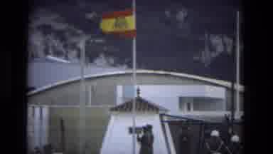 Andalusia Spain (1978): Person Lowers Red And Yellow Flag On A Clear Windy Day