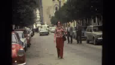 Andalusia Spain (1978): Woman Wearing Red Pants Walks In Middle Of Street On A