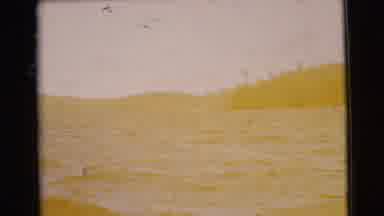 Traverse City Michigan-1956: Calm Blue Waves With Tree-Lined Shore