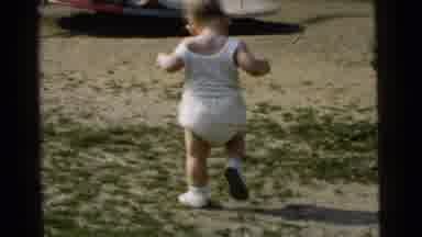 Gary Indiana USA-1961: Toddler In White Walking In Park Near Carousel