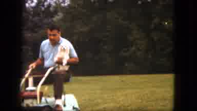 Duluth Minnesota (1963): Man Riding Lawn Mower Holding Dog