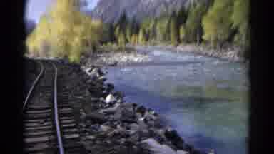 Colorado Springs (1967): Train Going Down A Railroad Track Next To A Stream And In